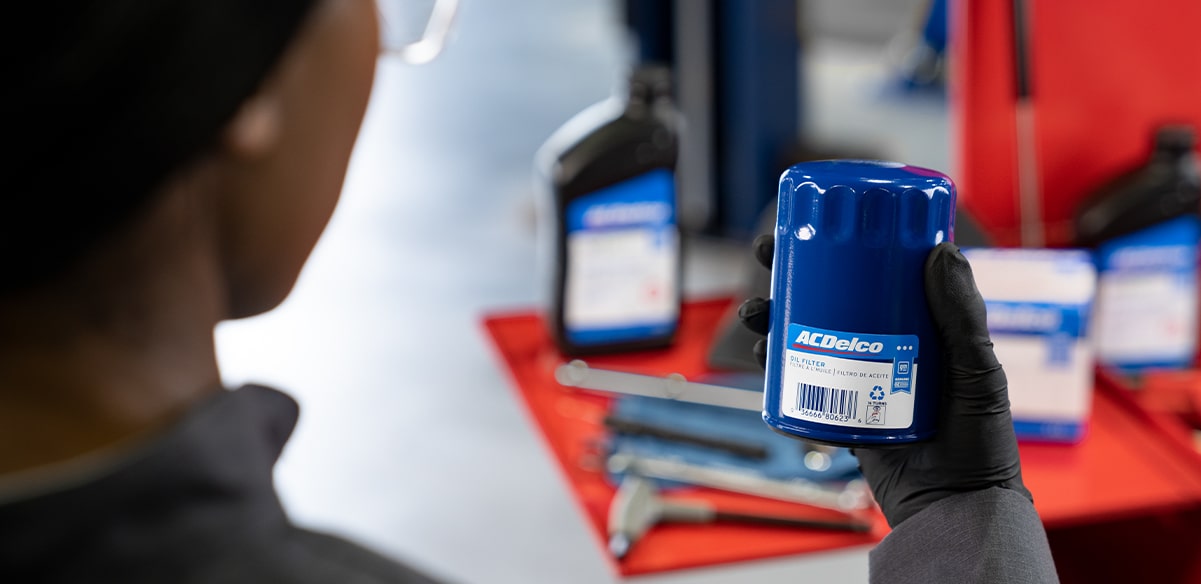 GM Technician Holding Up an ACDelco Oil Filter