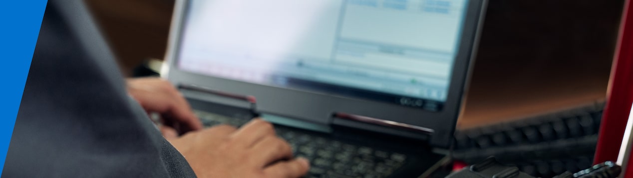 Closeup of a Technician's Hands Typing on a Laptop