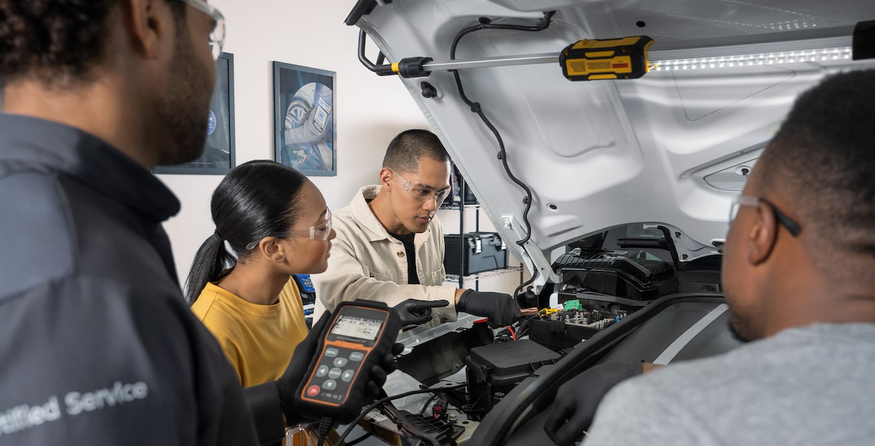 Group of Students Working on a Vehicle with a Certified Service Technician