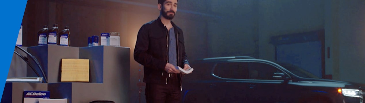 Man Standing Next to ACDelco Products on Display