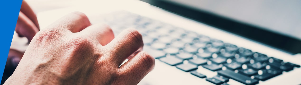 Closeup of a Man's Hands Typing on a Laptop