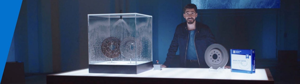 Man Standing Next to ACDelco Products on Display