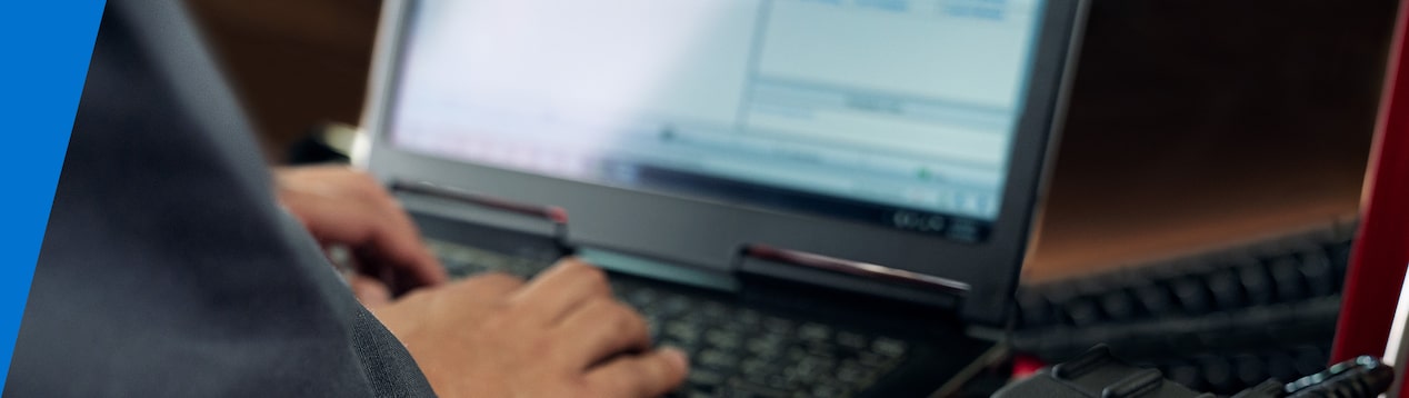 Closeup of a Man Typing on a Laptop