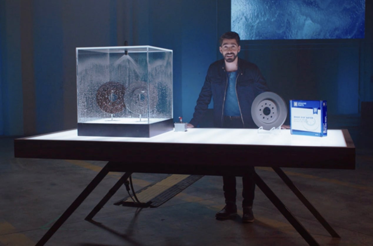 Man Standing at a Table With ACDelco Brake Rotors on Display